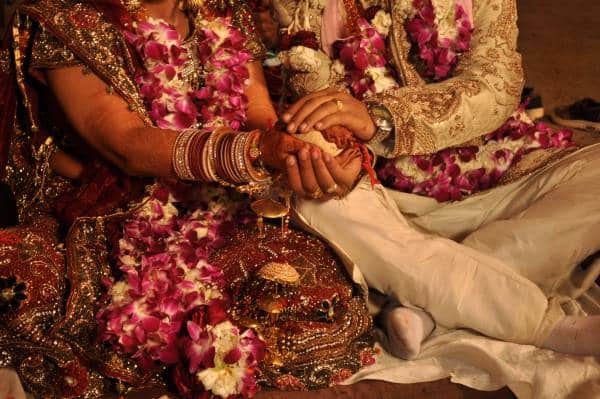 Traditional cultural wedding ceremony with intricate henna designs.