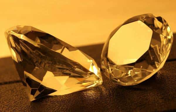 Exquisite diamond-like gems sparkling on a lustrous golden backdrop.