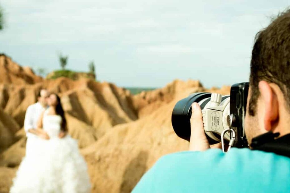 Bride in desert setting, photographer captures timeless wedding moment.